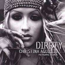 Picture with the words "DIRRTY CHRISTINA AGUILERA FEATURING REDMAN" under the image of Christina Aguilera's face. She has a nose earring, a tight fitting cap, and mascara-darkened eyes. Her hands are partially blocking the view of her face.