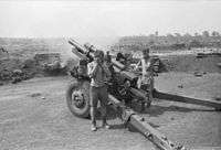 A black and white image of a New Zealand howitzer during Operation Coburg