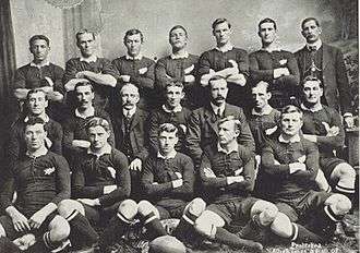 Photo of a group of rugby players posing in their uniforms.