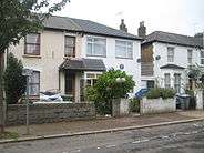 exterior of semi-detached house, with blue plaque on front wall