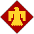 A red diamond with a yellow outline of a bird with small wings and a large tail