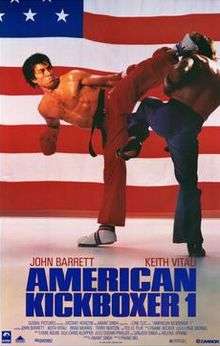 A kickboxer with red pants doing a side kick to another fighter in blue pants. The American flag is in the background and below this photo are the names John Barrett and Keith Vitali with the title "American Kickboxer 1" with the film credits.