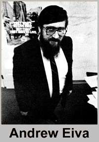 Black and white photograph of a bearded man in a dark suit and white shirt