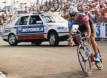 A cyclist riding a bike while preparing to round a corner.