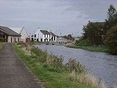 A photograph facing west along the Forth and Clyde Canal with Bainsford Bridge in the distance