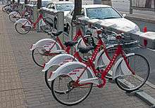 A rack of red-and-white bicycles, locked into place