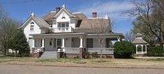 Two-story house with wraparound porch; gazebo in yard