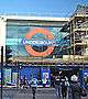 A building with scaffolding around it and a large window with a sign reading "UNDERGROUND" in white letters on a blue rectangle