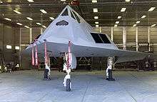 Aircraft parked inside an open hangar