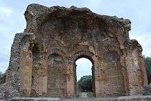 Half-missing building at Hadrian's Villa showing domed interior composed of orange peal-like sections rising from arched niches and door