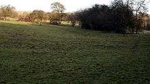 Disused railway line running across field