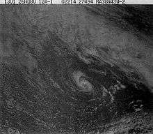 A satellite photo showing a small hurricane, there are a lot of clouds surrounding it