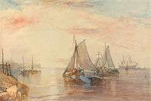 A group of small boats with drooping sails float on a smooth sea, just out from the shore. The glare of the sun turns the sky pink.