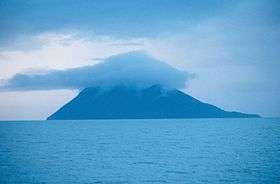 Photograph of Kaykak Island from offshore, believed to be the Bering Expedition Landing Site.