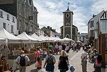 Street market with stalls under canvas roofs