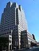  1 Metrotech Center, a high-rise clad in light-toned stone, viewed from street level