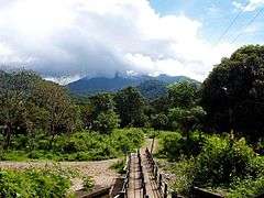 The bridge across Bavali river. The scenic cloudy hills in background