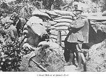 a man in uniform standing in front of a tent