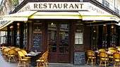 Paris street with a restaurant in the foreground