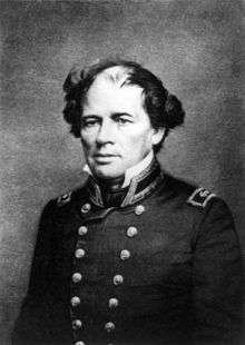 Photograph of a man, seated, in double-breasted naval uniform