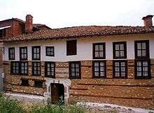 Brown-and-white building with two rows of windows