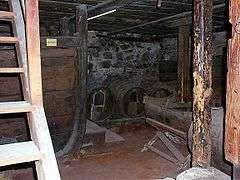 Small dark space, with casks and wooden ladder