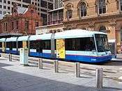 Two-tone blue tram with doors open