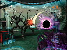 View of a futuristic looking room; mantis-like enemies on powered armor - one firing a red beam - approach the player, whose weapon (a large cannon) is visible in the corner of the screen. Something resembling a black hole is seen on the right side of the enemies, while a gray and red metallic crate is to their left. The image is a simulation of the heads-up display of a combat suit's helmet, with a crosshair surrounding the enemy and two-dimensional icons relaying game information around the edge of the frame.