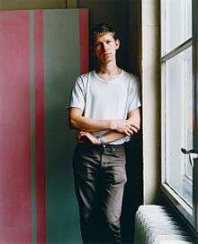 man standing beside window