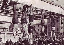 corpses hanging by feet including Mussolini next to Petacci at Piazzale Loreto, Milan, 1945