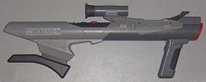 Bazooka-shaped, gray light gun with built-in shoulder support and orange accents, gray scope attached and forward grip