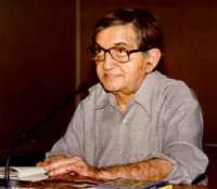 A man sitting by desk.