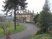 small two-storey building in a parkland setting