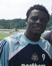 Head and upper torso of a young black man wearing a sports shirt with a number nine on the chest.