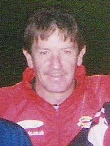 Smiling middle-aged white man wearing a red anorak