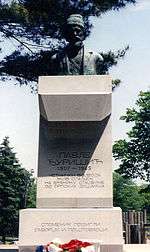 a concrete plinth with a bust on top of it