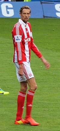 A man in a football uniform, playing in a football match