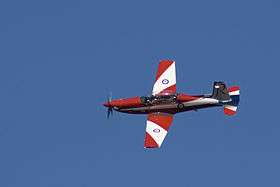 Single-engined aircraft with red-and-white livery, in flight