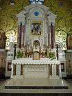 Main altar showing the marble detail and gold mosaic.