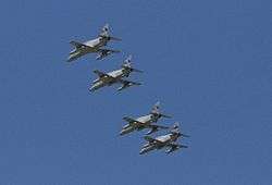 Four monoplane aircraft flying in close formation. The aircraft are painted grey and have been photographed from below.