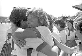 Two women joyfully embrace