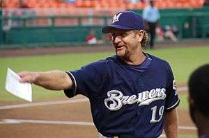 A man in a navy blue baseball jersey with "Brewers" written across the chest.