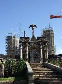 Crumbling partial walls of queen's palace supported by scaffolding