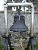 A ship's bell exhibited outside a church