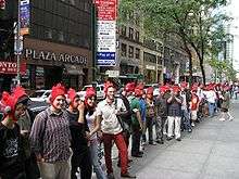 Customers wearing rooster hats while waiting in line for the start of Scribblenauts launch event