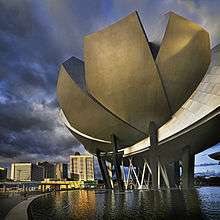 A lotus-inspired building designed by Moshie Safdie that features 10 “fingers” anchored by a unique round base in the middle.