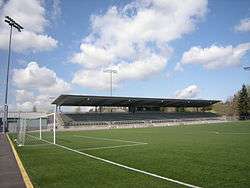 A soccer field with a single-tier grandstand