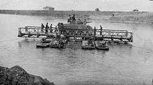 A tank on a barge mid river