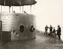 Photo showing Officers standing on deck, one seated