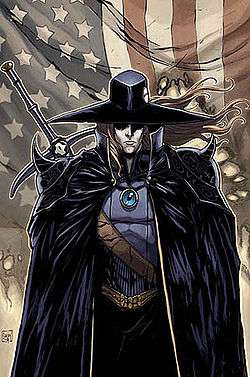 D is shown in his traditional over-cloak and traveler's hat with blond hair, his curved longsword slung over his right shoulder. He stands in front of a tattered American flag.